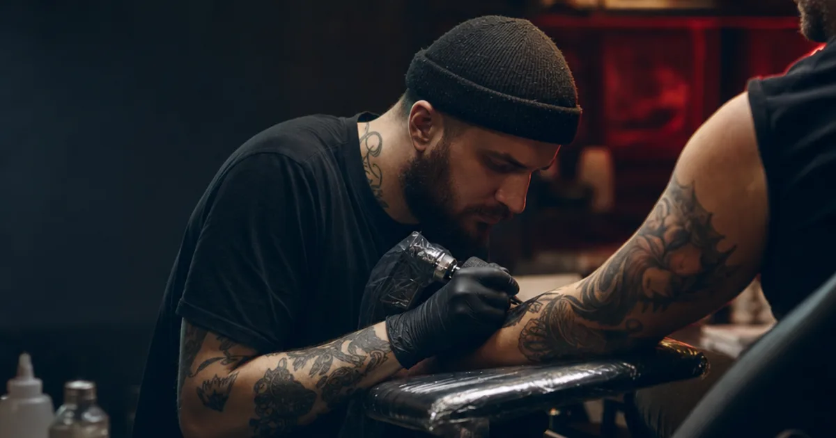 Fresh tattoo wrapped in cling film — proper aftercare starts from day one